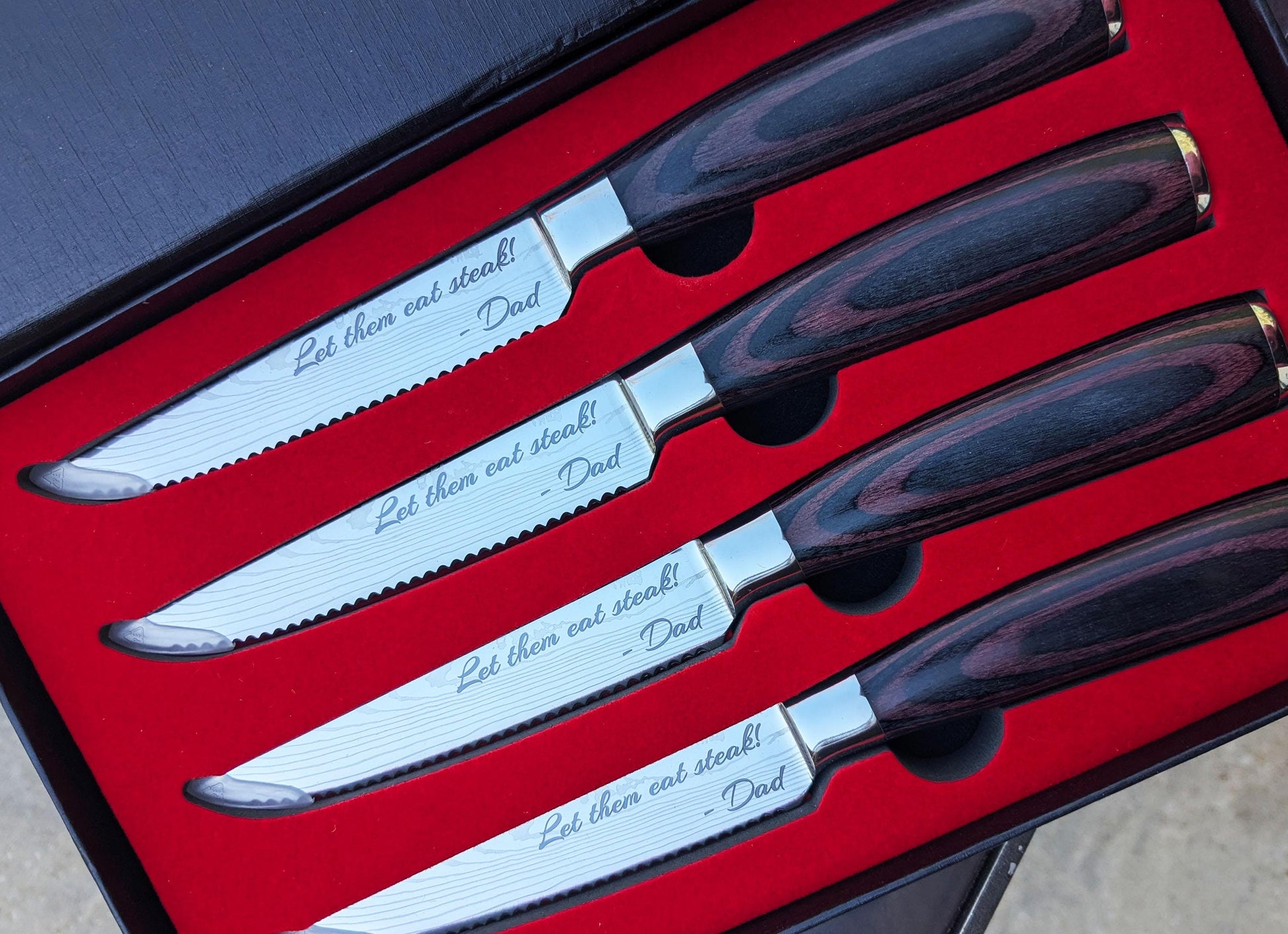Close up of laser engraved personalization on stainless steel steak knife blade