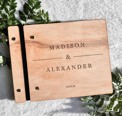 Rustic engraved wedding guest book open showing interior pages for guest signatures